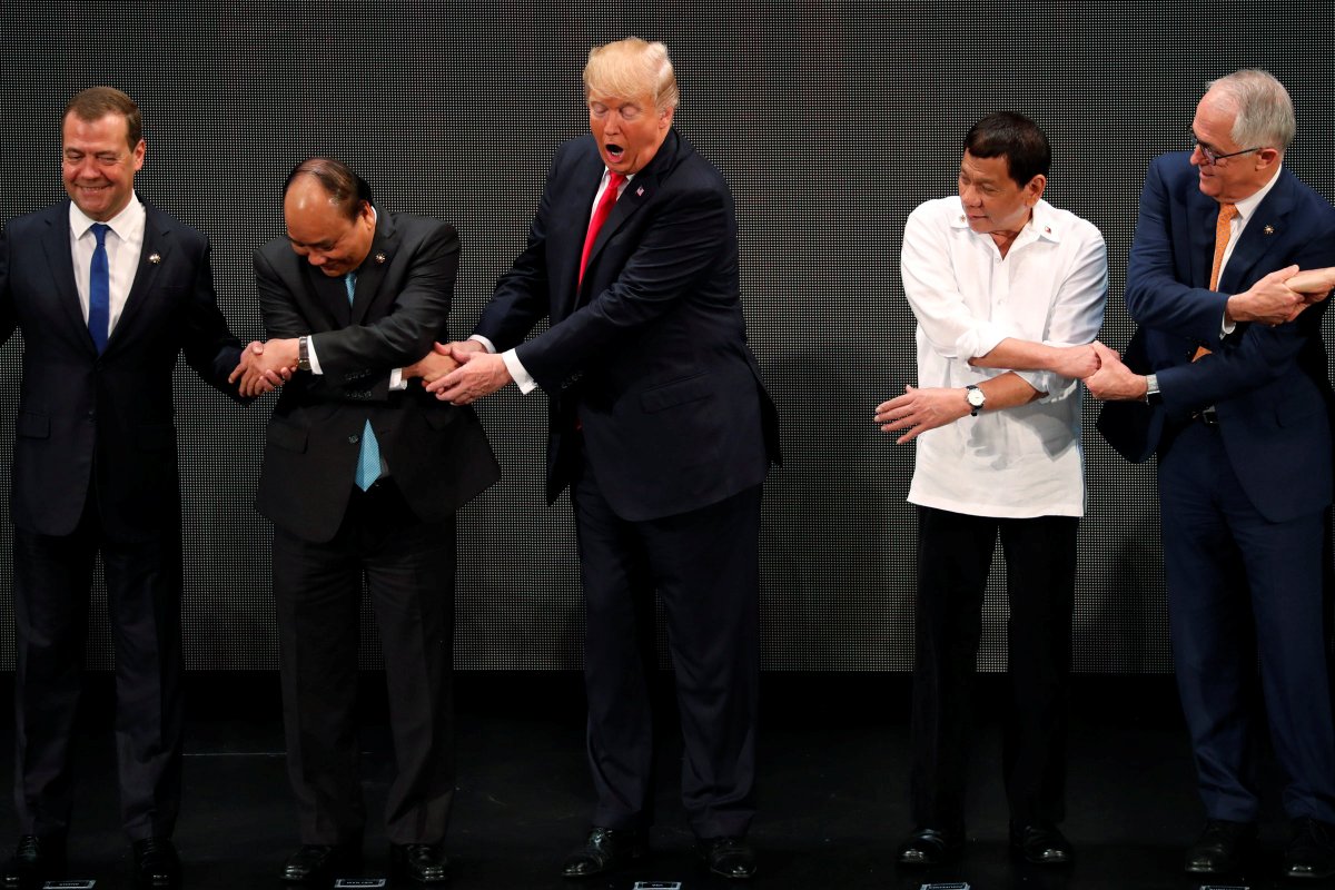 US President Donald Trump reaches out to President Rodrigo Duterte for the ASEAN traditional handshake   