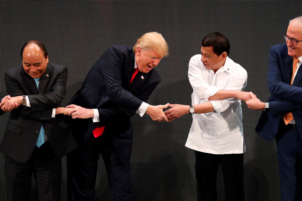 US President Donald Trump reaches out to President Rodrigo Duterte for the ASEAN traditional handshake   