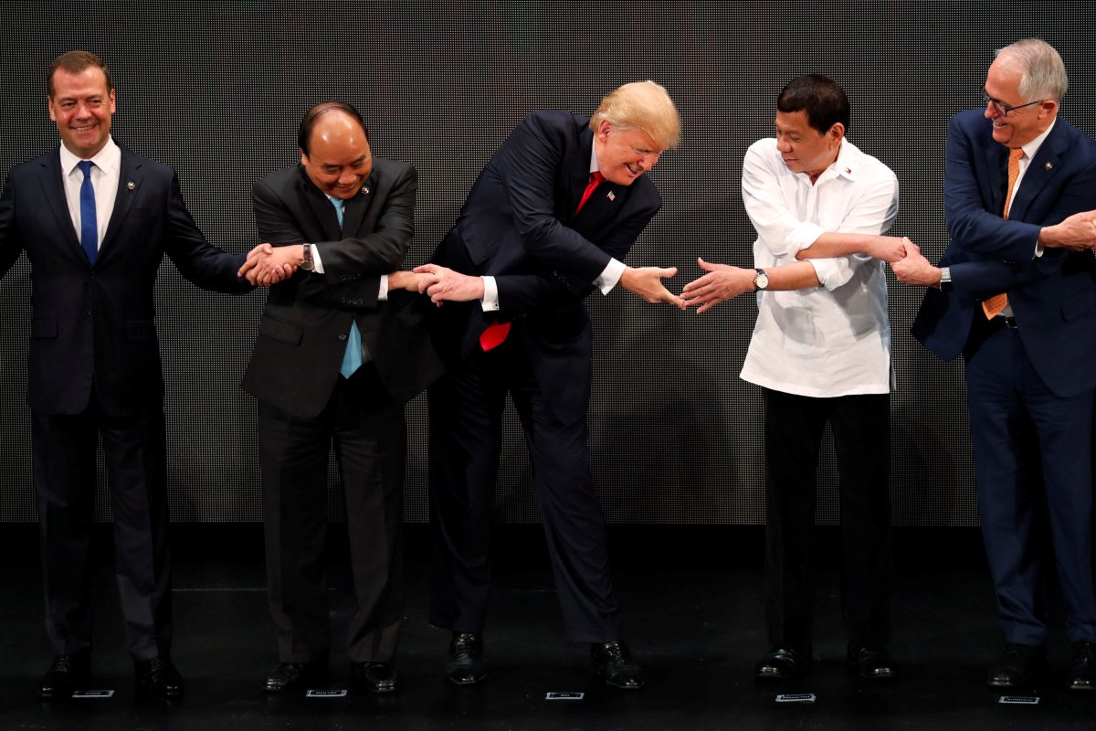 US President Donald Trump reaches out to President Rodrigo Duterte for the ASEAN traditional handshake   