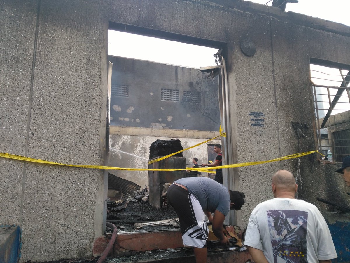 More photos from Caloocan police station fire. Roof has completely collapsed; sounds of ammunition going off still ongoing. Police still trying to salvage  equipment 